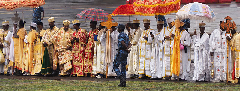 Orthodox priests wait for festivities to begin.