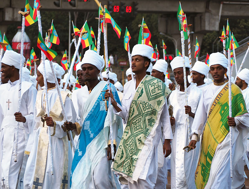 More celebrants arrive carrying prayer staffs and Ethiopian flags.