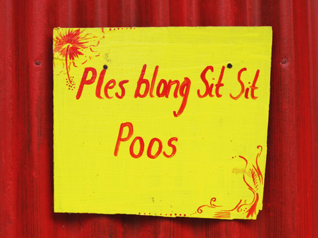 A sign written in Bislama on a toilet door translates literally as “Place belong (of) shit-shit”