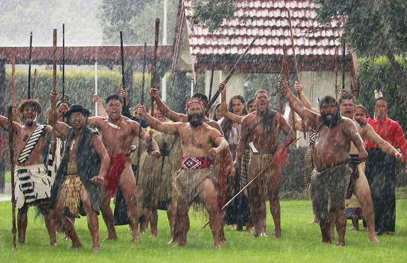 Members of mass haka group Taitokerau Tira Haka welcome guests in the rain ahead of the first official commemorations of the New Zealand Wars