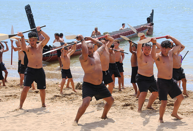 Kaihoe (paddlers) perform a haka on Tii Beach