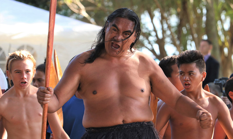 A kaihoe (paddler) performs a haka to welcome Governor-General Dame Patsy Reddy