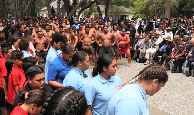 Kaihoe (paddlers) perform a haka for the newly knighted Sir Hekenukumai Puhipi