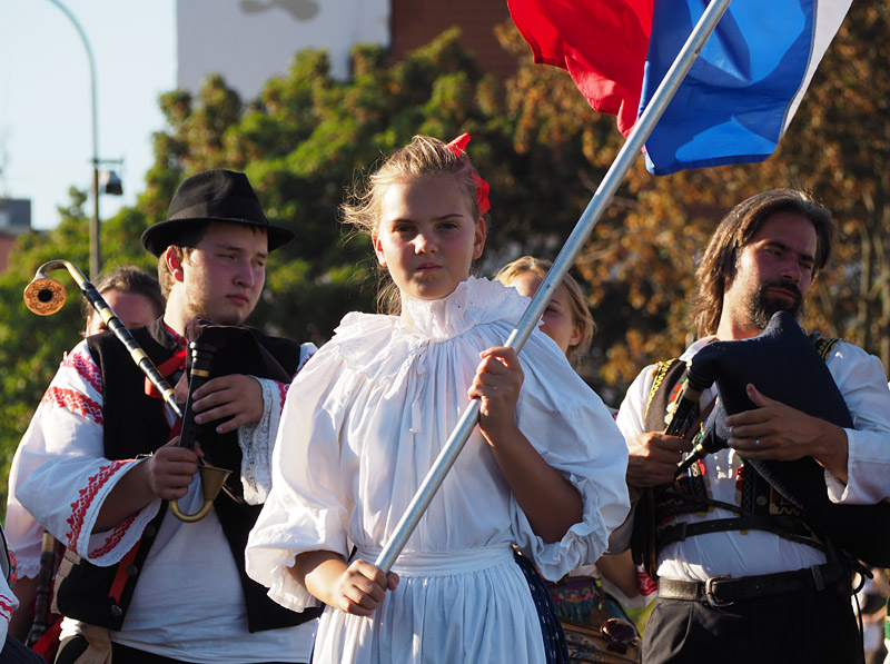 A young flagbearer leads a Slovak bagpipe band