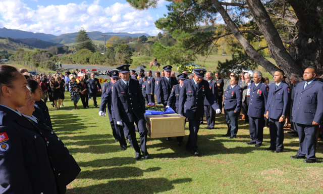 MAY: A guard of honour lines the entrance to Waimamaku cemetery as long-serving Omapere fire chief Dene Preston is laid to rest. Photo: Peter de Graaf