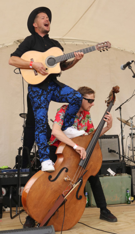 OCTOBER: White Chapel Jak's Nathan Boston picks an unusual spot to play while bassist Michael White carries on undeterred at Paihia’s It! Festival. Photo: Peter de Graaf