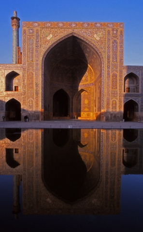 An iwan (portal) of the 17th century Imam Mosque is reflected in a pool, Esfahan
