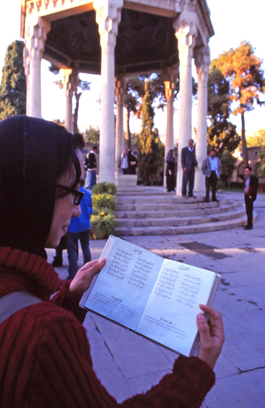 A girl reads poetry at the tomb of the 14th century Persian poet Hafez, in the city of Shiraz