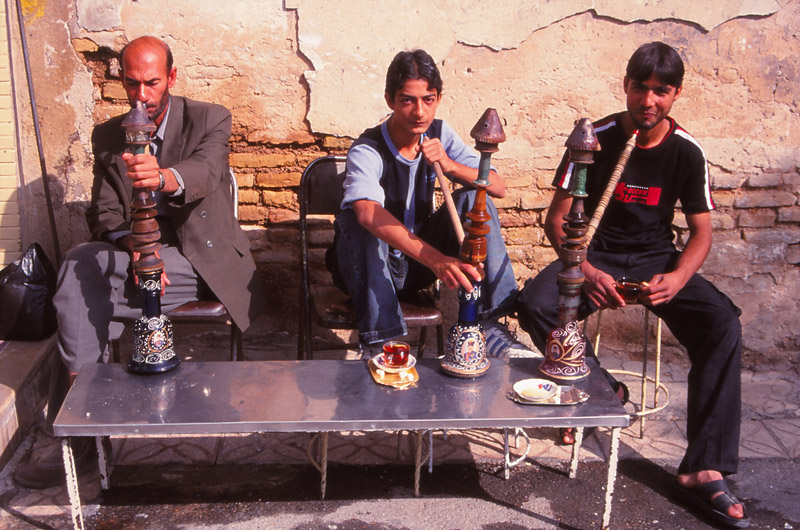 Men enjoying a qalyan (waterpipe) at a café in Shiraz