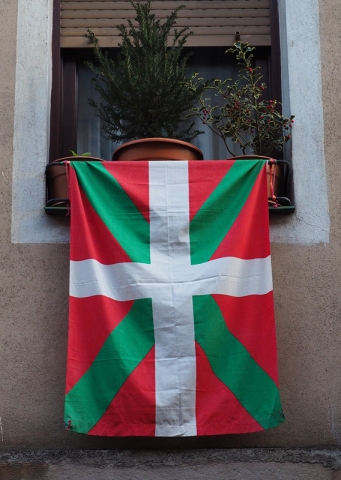 The Basque flag hangs from a window in Bilbao’s old town, Spain
