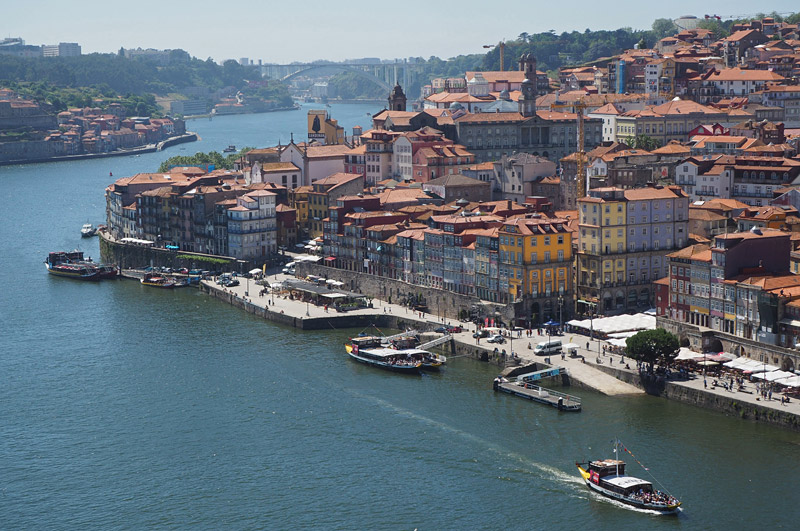 Bustling river front in Porto, he city that gave Portugal – and port wine – its name