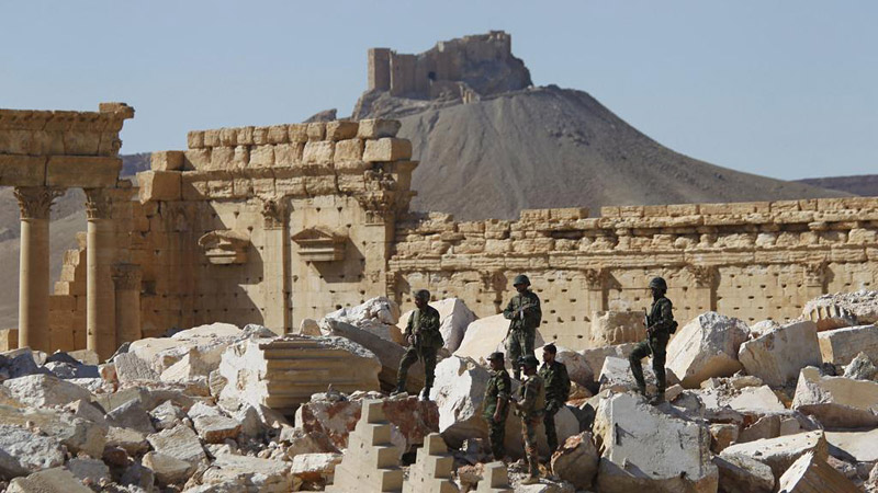 Syrian soldiers in the ruins of Bel Temple after recapturing Palmyra. Photo: Omar Sanadiki/Reuters
