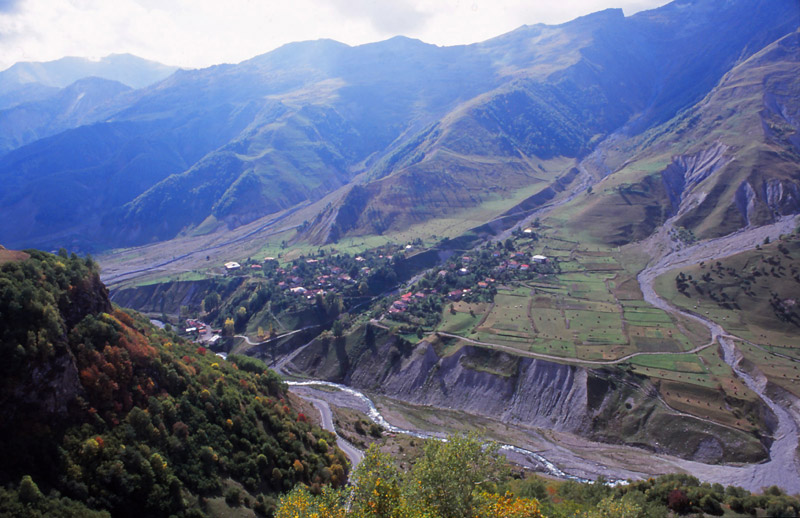 A village clings to the side of a valley in the Caucasus Mountains