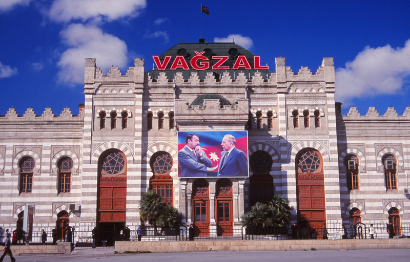 Baku railway station with a billboard of the president and his son