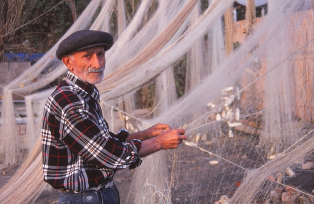 A Caspian Sea fisherman repairs a net at Lenkeran