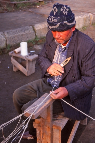 A Caspian Sea fisherman repairs a net at Lenkeran