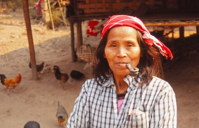 A woman enjoys a pipe in Ban Nalan Neua village