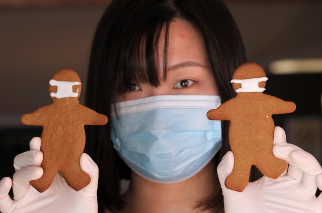April: Barista Shujing Piao with coronavirus-themed gingerbread men at Kerikeri's Café Cinema. Photo: Peter de Graaf