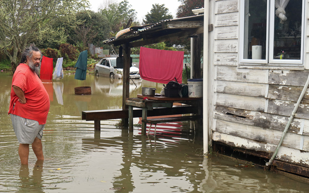 July: Skip Kidwell surveys the flooding around his home, the worst-hit property on the worst-hit street in Moerewa. Photo: Peter de Graaf