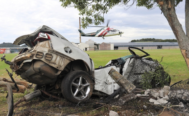 November: The Northland Rescue Helicopter lifts off with an injured driver who crashed after allegedly kidnapping a man and forcing him to withdraw money from a Paihia bank. Photo: Peter de Graaf