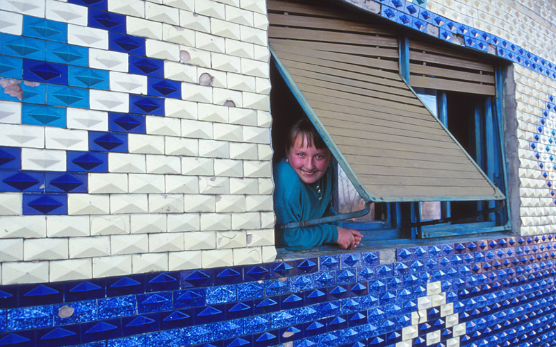Helenka peeks from a window of her home in Rovensko.