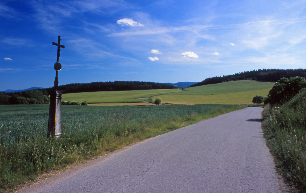 Landscape with roadside cross in the Šumava Mountains, South Bohemia