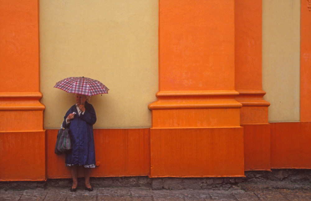 A woman shelters from the rain at the Church of St John of Nepomuk in West Bohemia