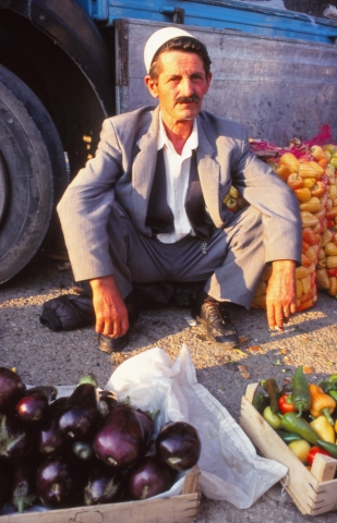 Kosovo, 1997: A trader in the market of Peja, Kosovo's second city, wearing the traditional Albanian fez