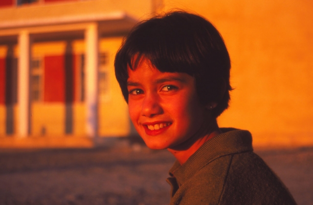 Majlinda smiles for a sunset photo outside her school in Krujë