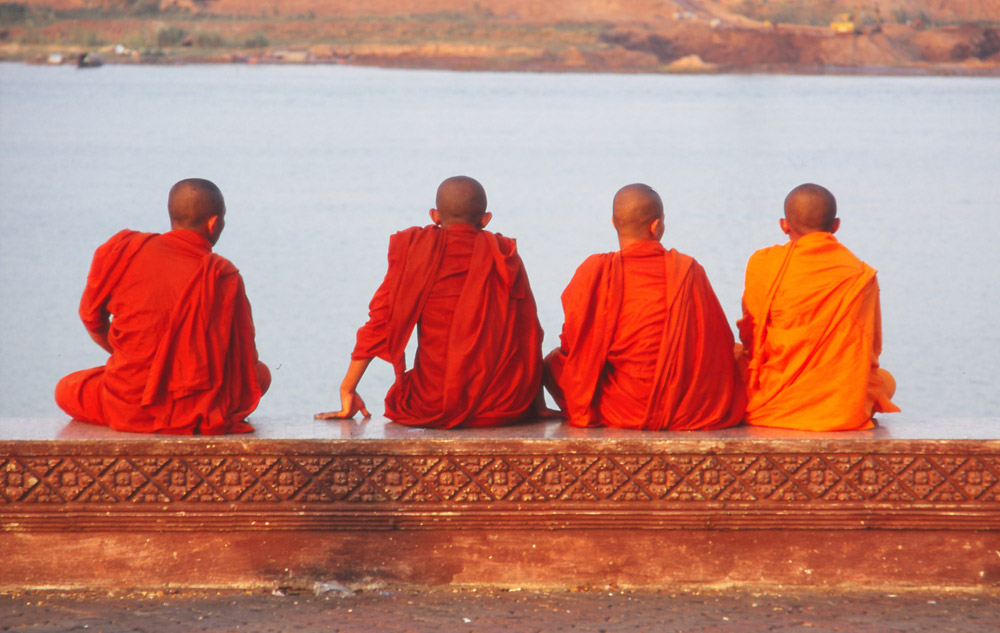Monks relax by the Tonlé Sap River in Phnom Penh