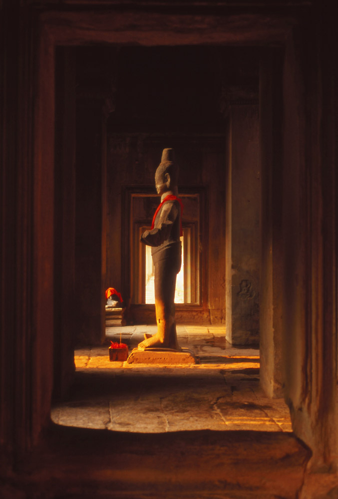 A statue catches the light at Angkor Wat