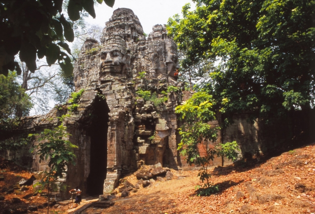 An enigmatic face gazes from the western gate of Angkor Thom, the 12th century capital of the Khmer Empire