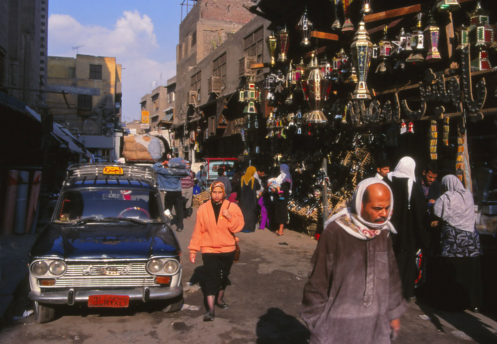 A lantern shop displays its wares on a busy side street in Cairo
