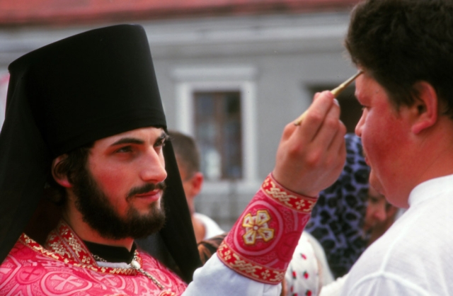 An orthodox priest blesses a church-goer during a festival in Chernivtsi