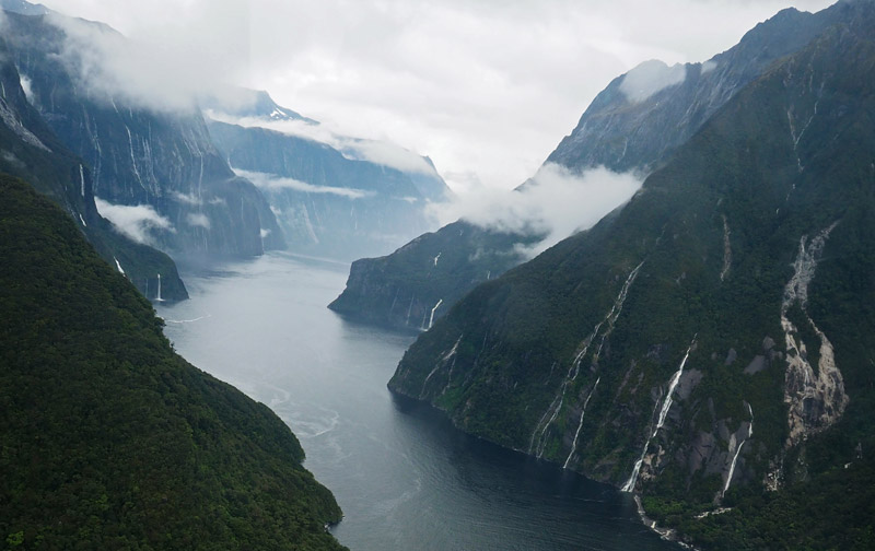 Waterfalls gush from the glacier-carved mountainsides of Milford Sound