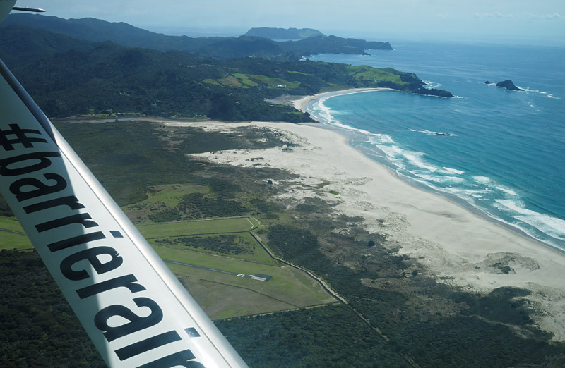The plane swoops low over Kaitoke Beach as it approaches Claris air strip