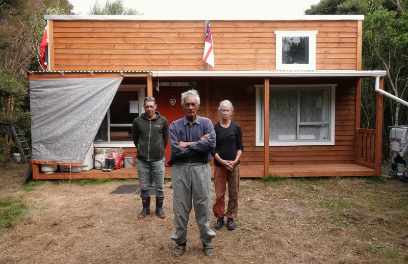 Kaumātua Matutaera Clendon, centre, with nephew John Clendon and partner Bronna Brown at Whare Otupoho, a tiny house built on Moturua Island. 